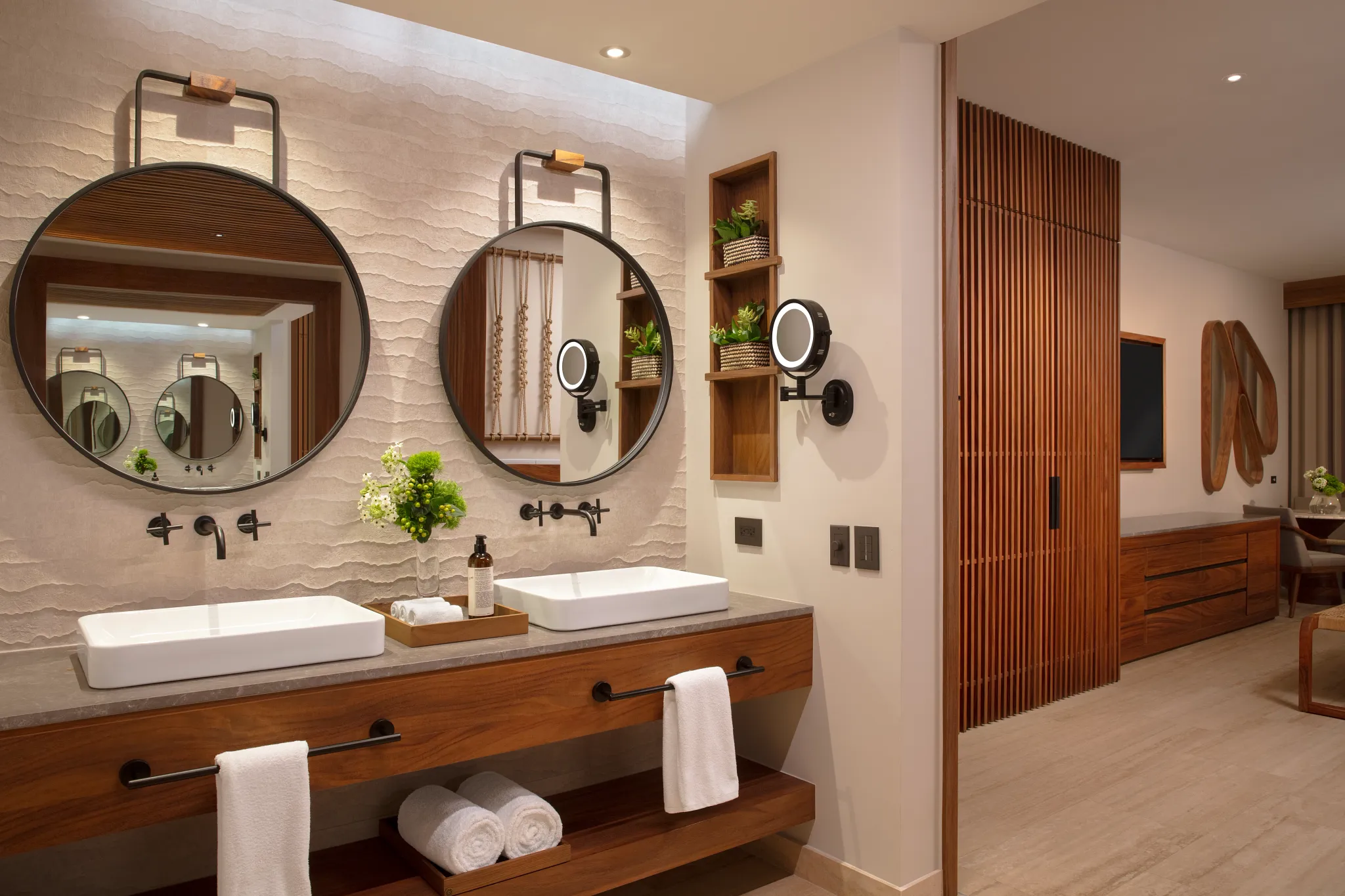 Junior Suite Ocean View bathroom vanity with double sinks and round mirrors at Secrets Playa Blanca Costa Mujeres.