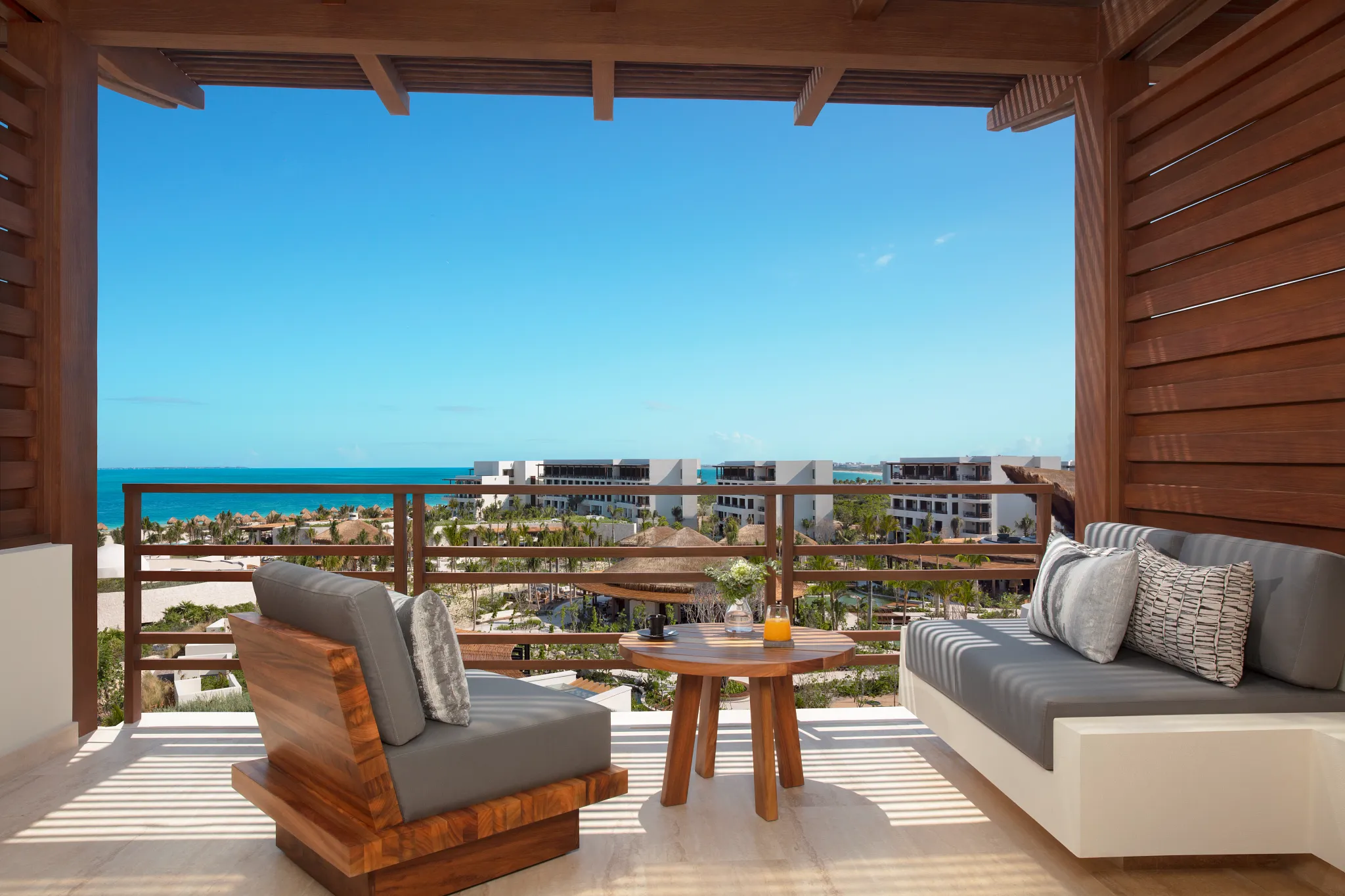 Junior Suite Ocean View private terrace with seating and panoramic ocean views at Secrets Playa Blanca Costa Mujeres.