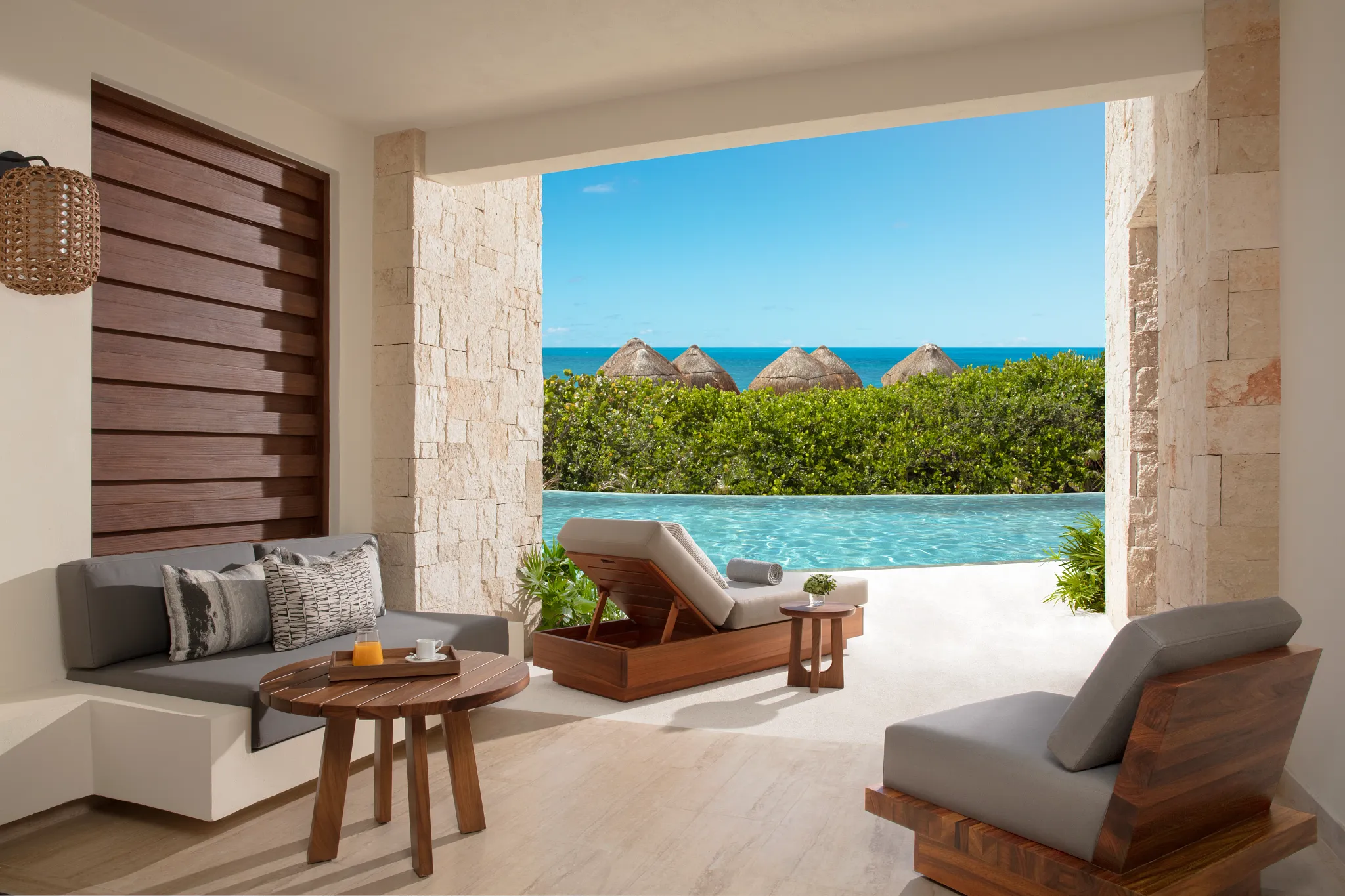 Preferred Club Junior Suite Swim Out Ocean Front bedroom with king bed and ocean view balcony at Secrets Playa Blanca Costa Mujeres.