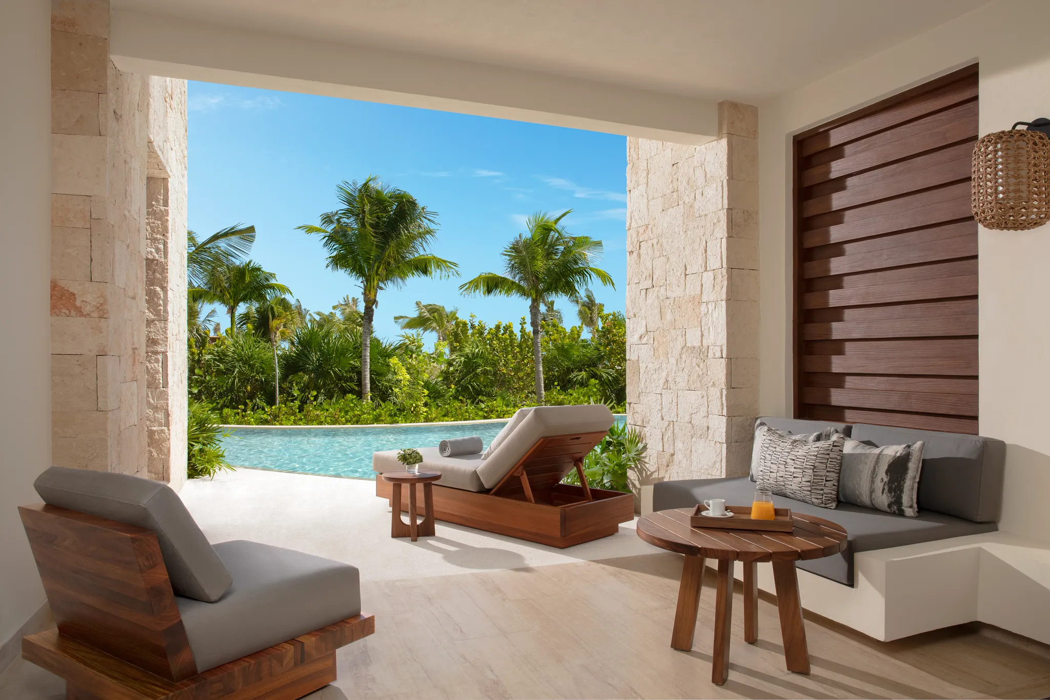 Preferred Club Junior Suite Swim Out terrace with lounge seating and direct pool access at Secrets Playa Blanca Costa Mujeres.