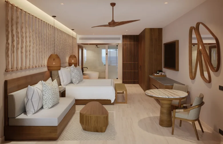 Preferred Club Junior Suite Tropical View with king bed and modern seating area at Secrets Playa Blanca Costa Mujeres.