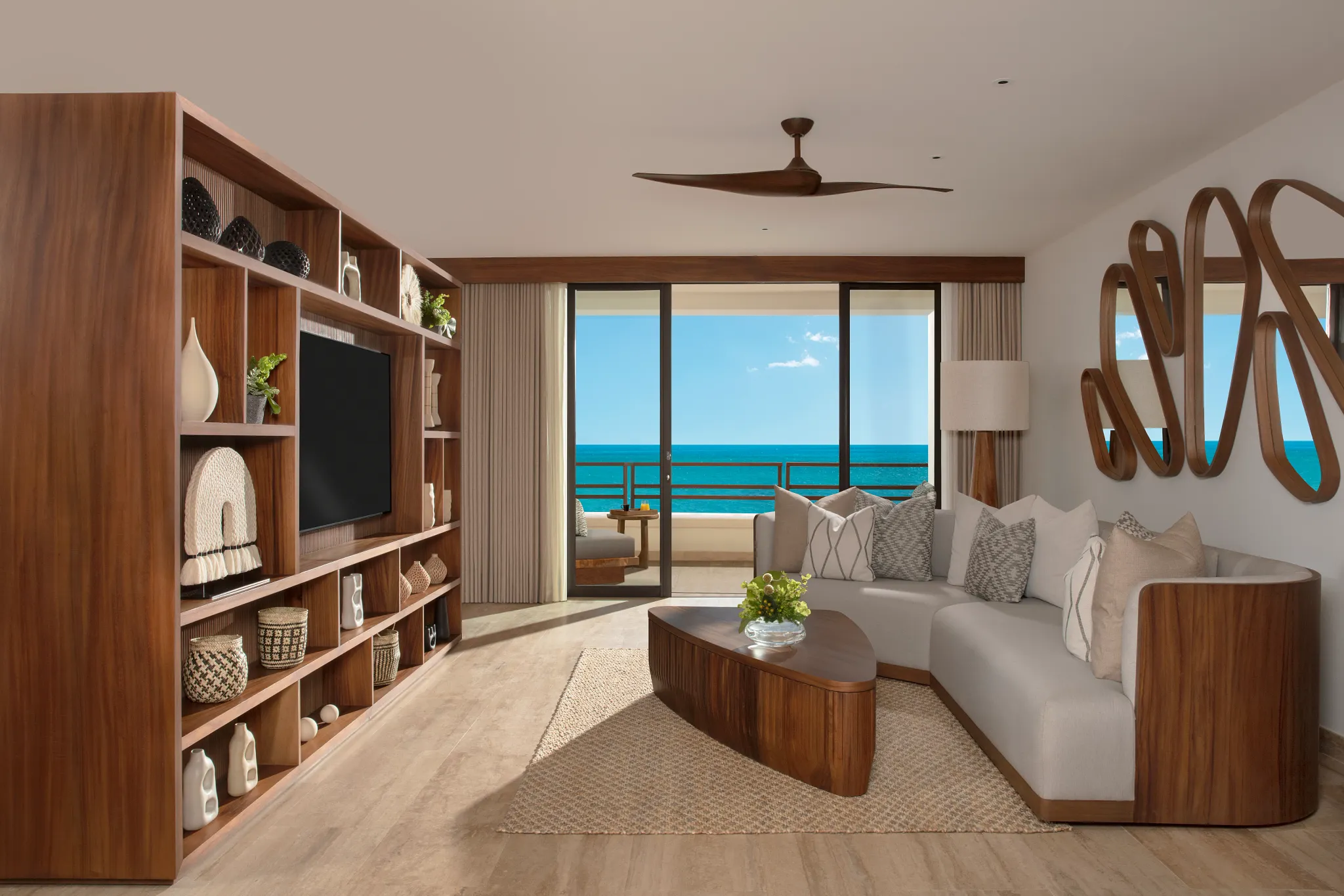 Spacious living room with sofa and ocean view balcony in Preferred Club Master Suite at Secrets Playa Blanca Costa Mujeres.