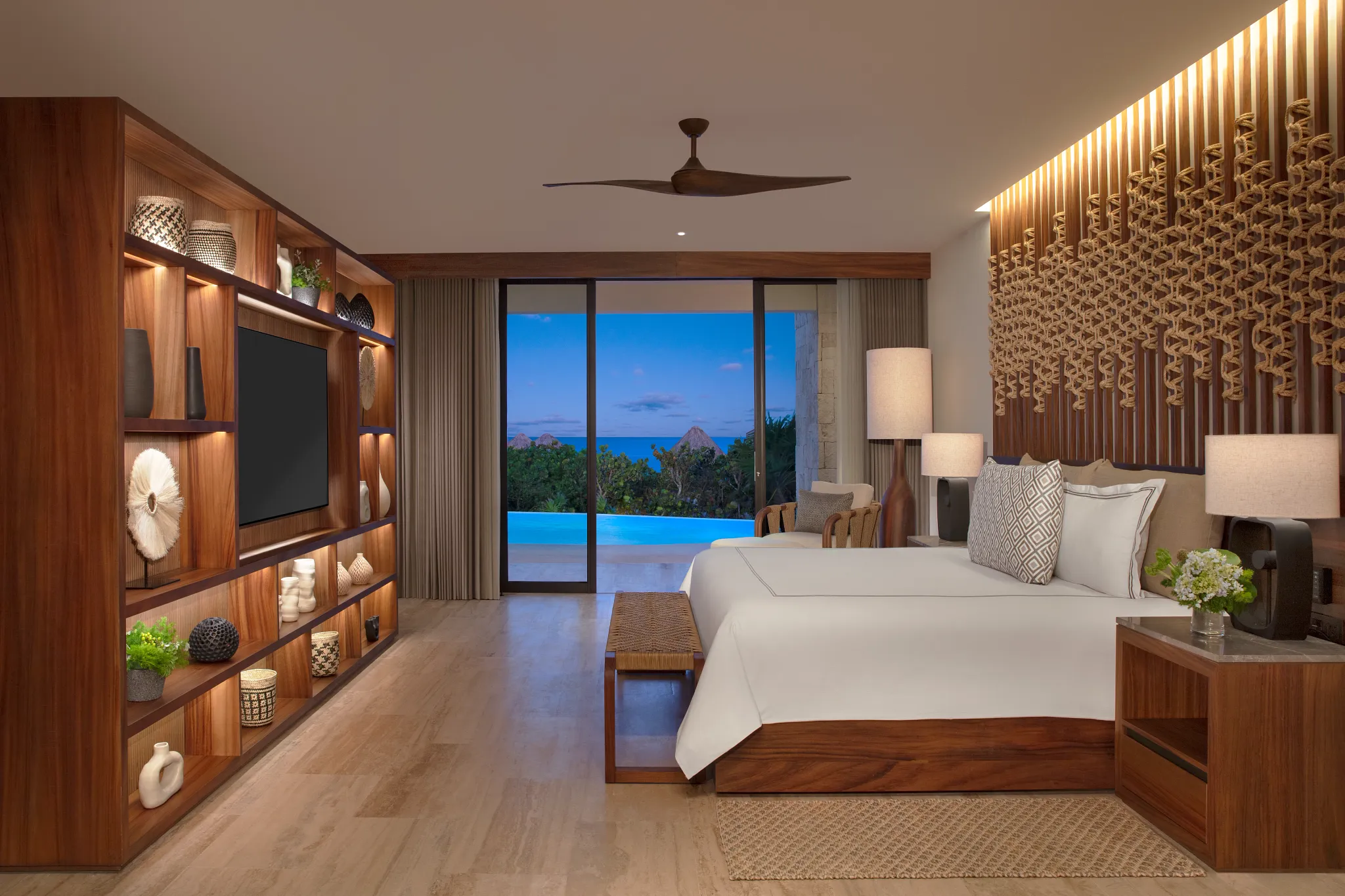 Oceanfront bedroom with king bed and swim-out pool view in Preferred Club Master Suite at Secrets Playa Blanca.
