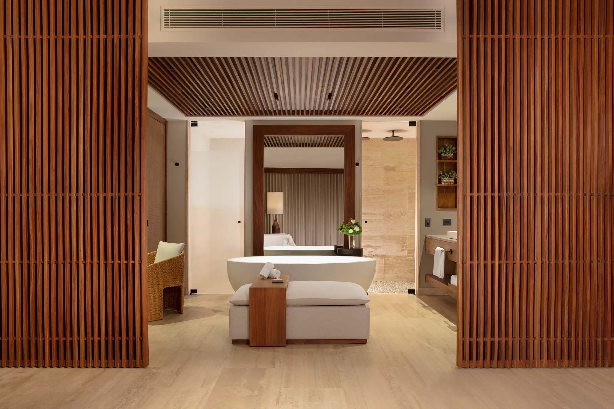 Luxury bathroom with freestanding soaking tub and wood accents at Secrets Playa Blanca Costa Mujeres suite.