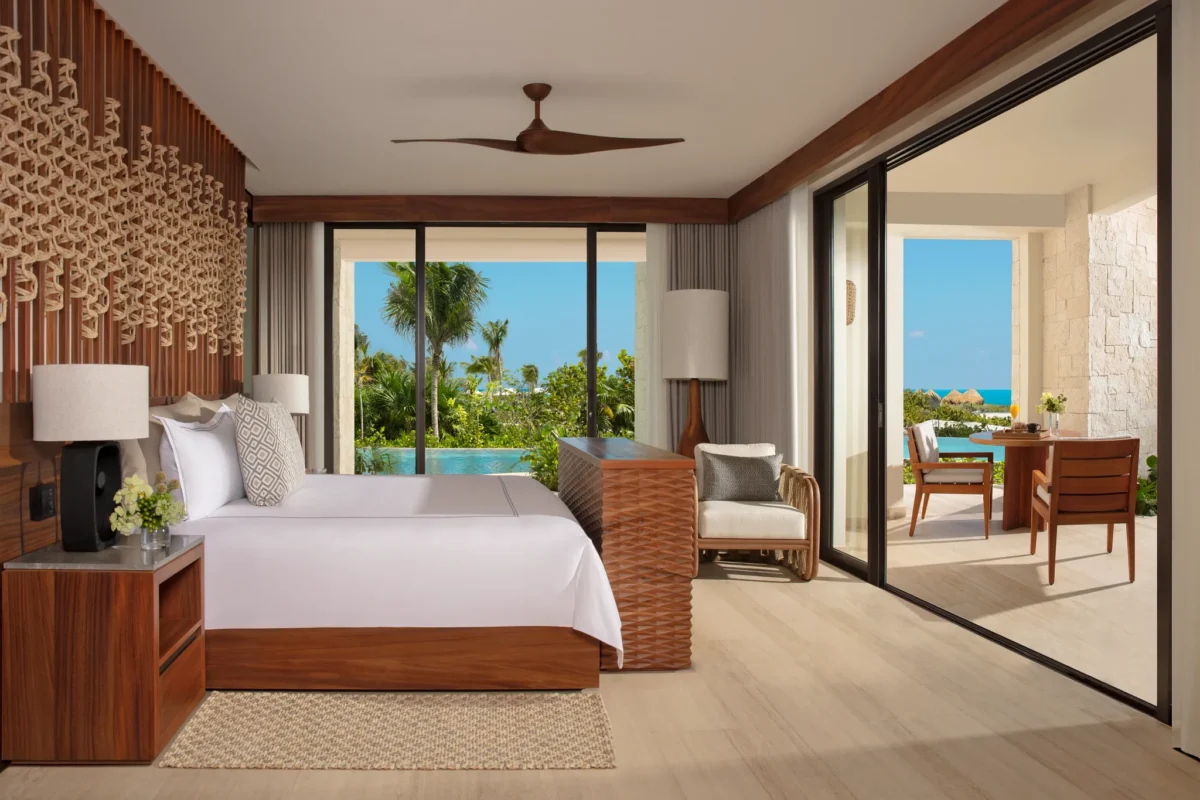 Presidential Suite bedroom with king bed and swim-out pool view at Secrets Playa Blanca Costa Mujeres.