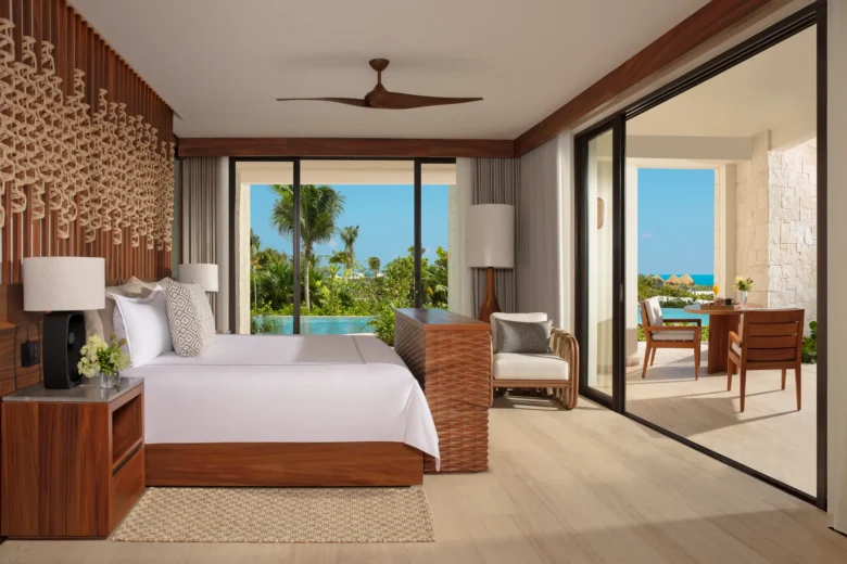 Presidential Suite bedroom with king bed and swim-out pool view at Secrets Playa Blanca Costa Mujeres.