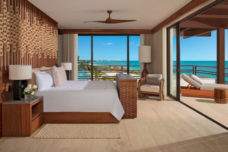 Oceanfront bedroom with king bed and private terrace view in Presidential Suite at Secrets Playa Blanca.