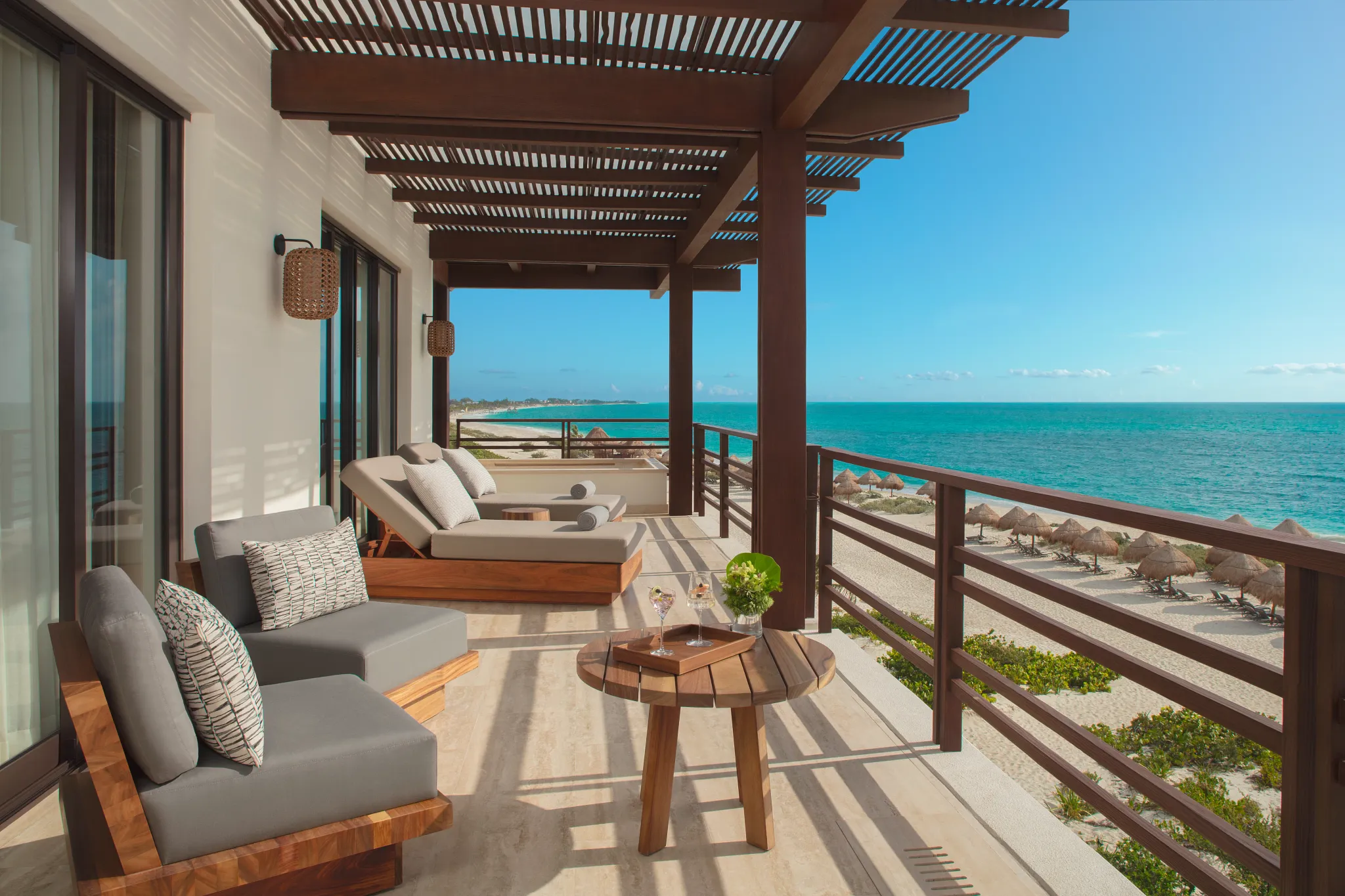 Presidential Suite oceanfront terrace with lounge seating and beach views at Secrets Playa Blanca Costa Mujeres.