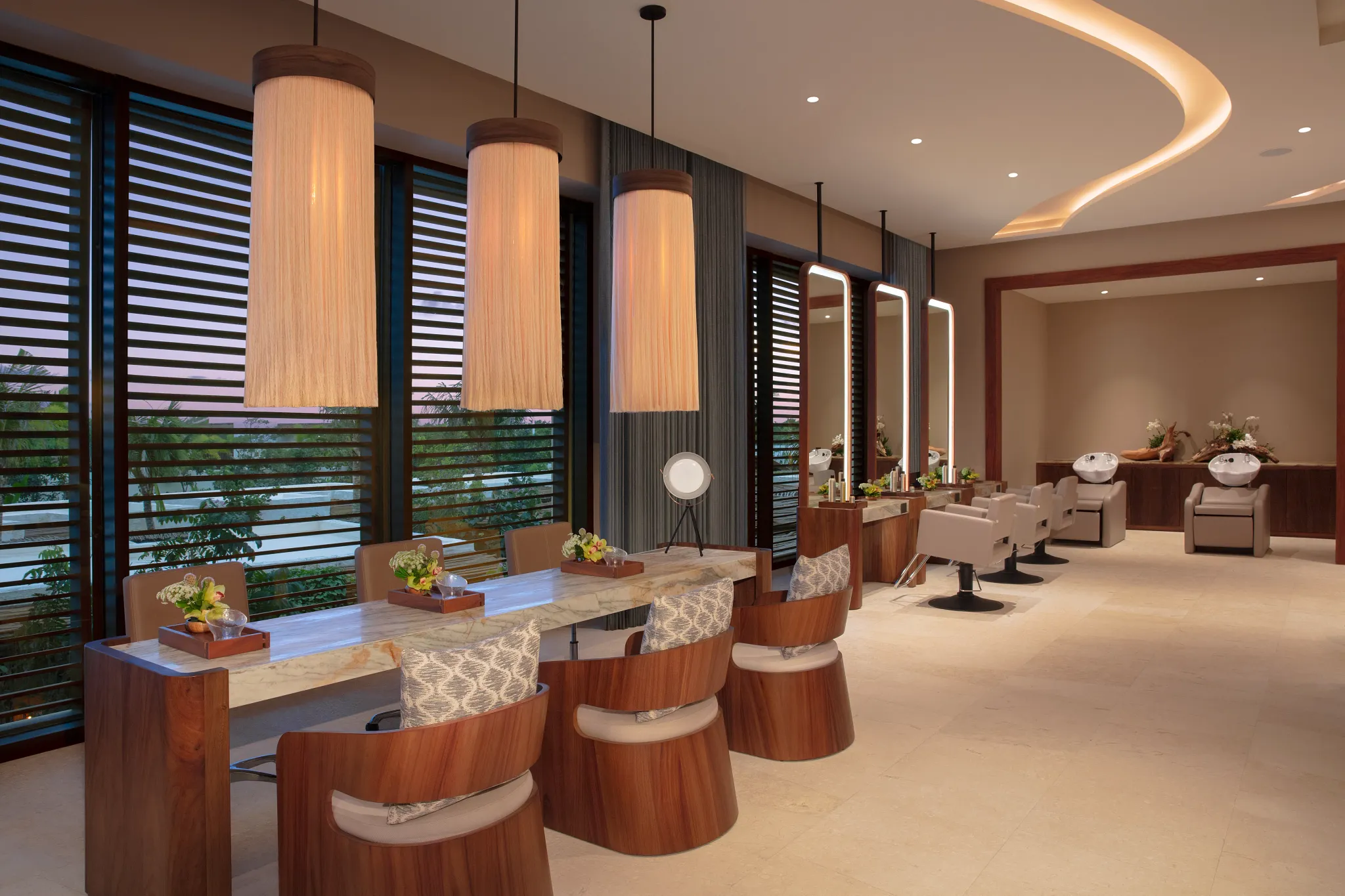Modern spa salon with styling chairs and mirrors at Secrets Playa Blanca Costa Mujeres, offering luxury beauty services in a tranquil setting.