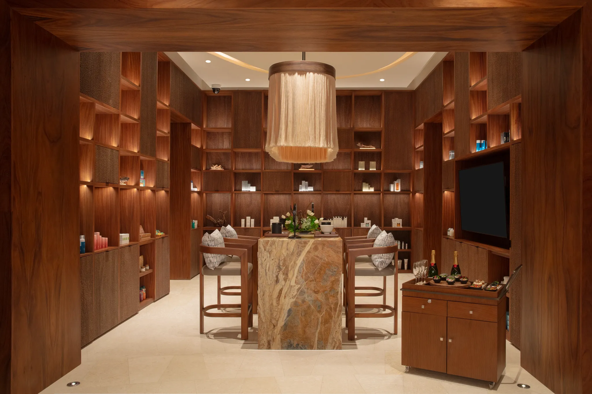 Luxury spa skin bar with skincare displays and seating area at Secrets Playa Blanca Costa Mujeres, perfect for personalized beauty treatments.